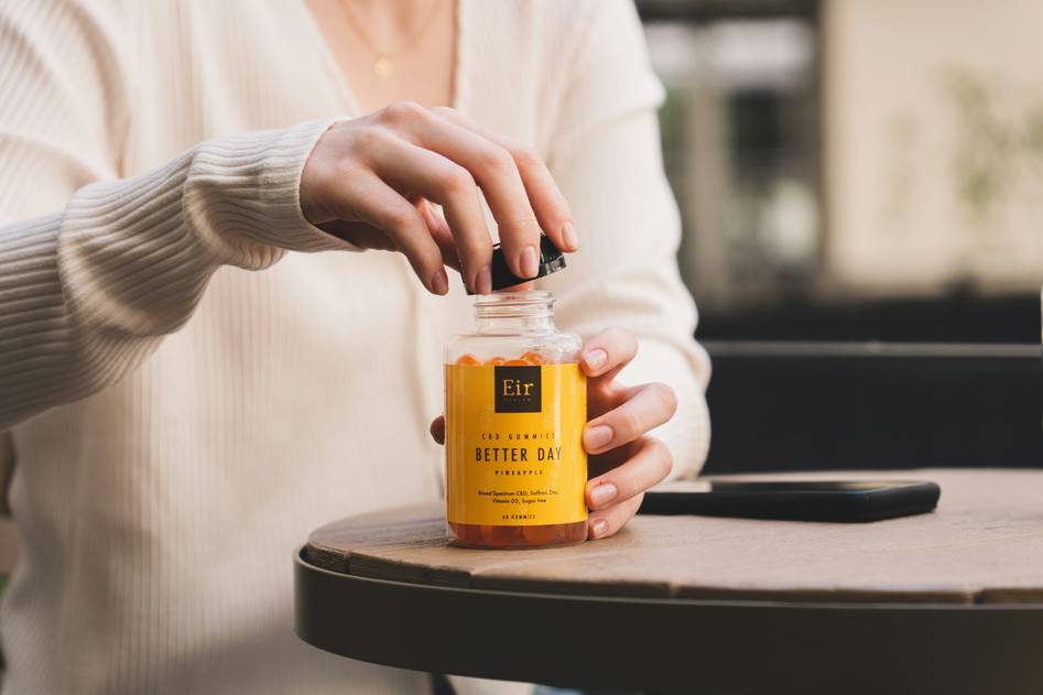 Minimal flat-lay of zinc capsules with fresh botanicals